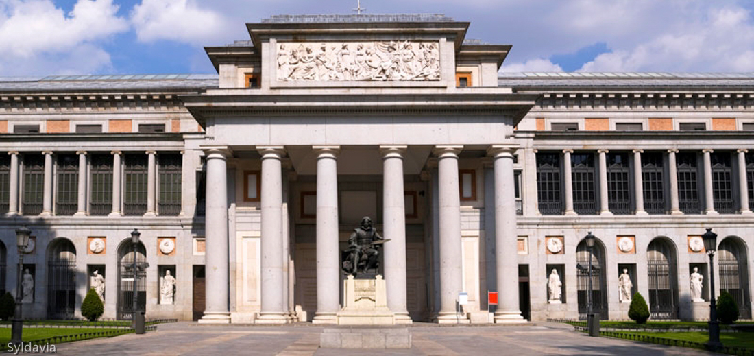 "View of the entrance of the Prado Museum, Madrid (Spain).). In the foreground, the famous Spanish painter, Velazquez."